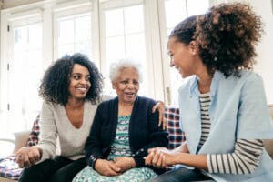 caregiver-talking-with-senior-and-adult-daughter