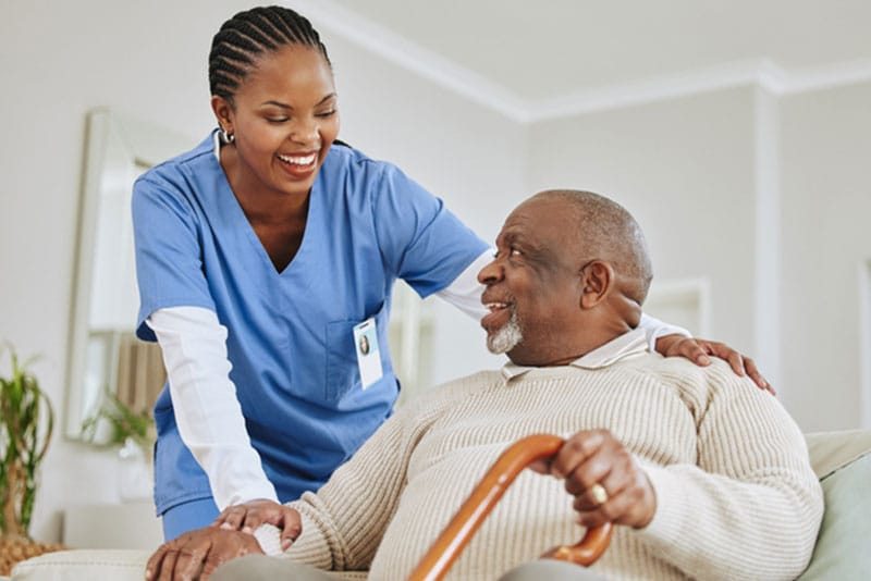 caregiver talking with senior man