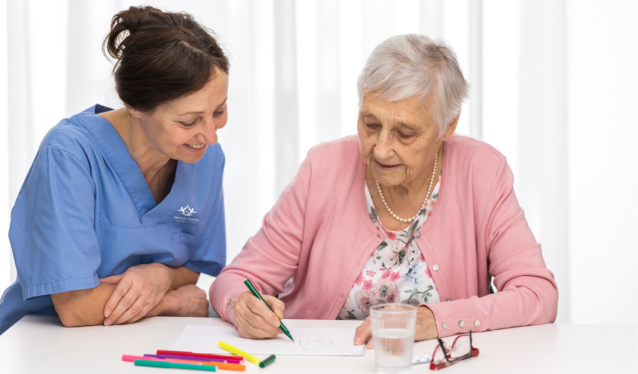 Caregiver and senior client work on memory activities