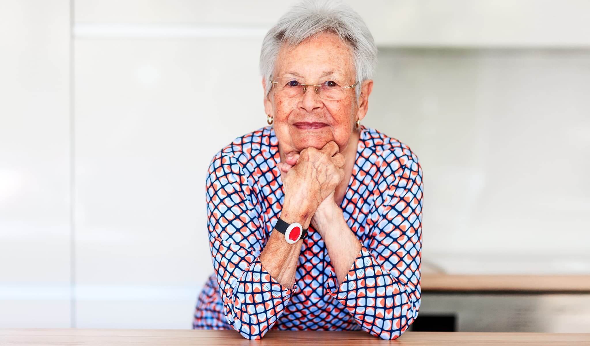 Senior client wearing a personal emergency services wristband