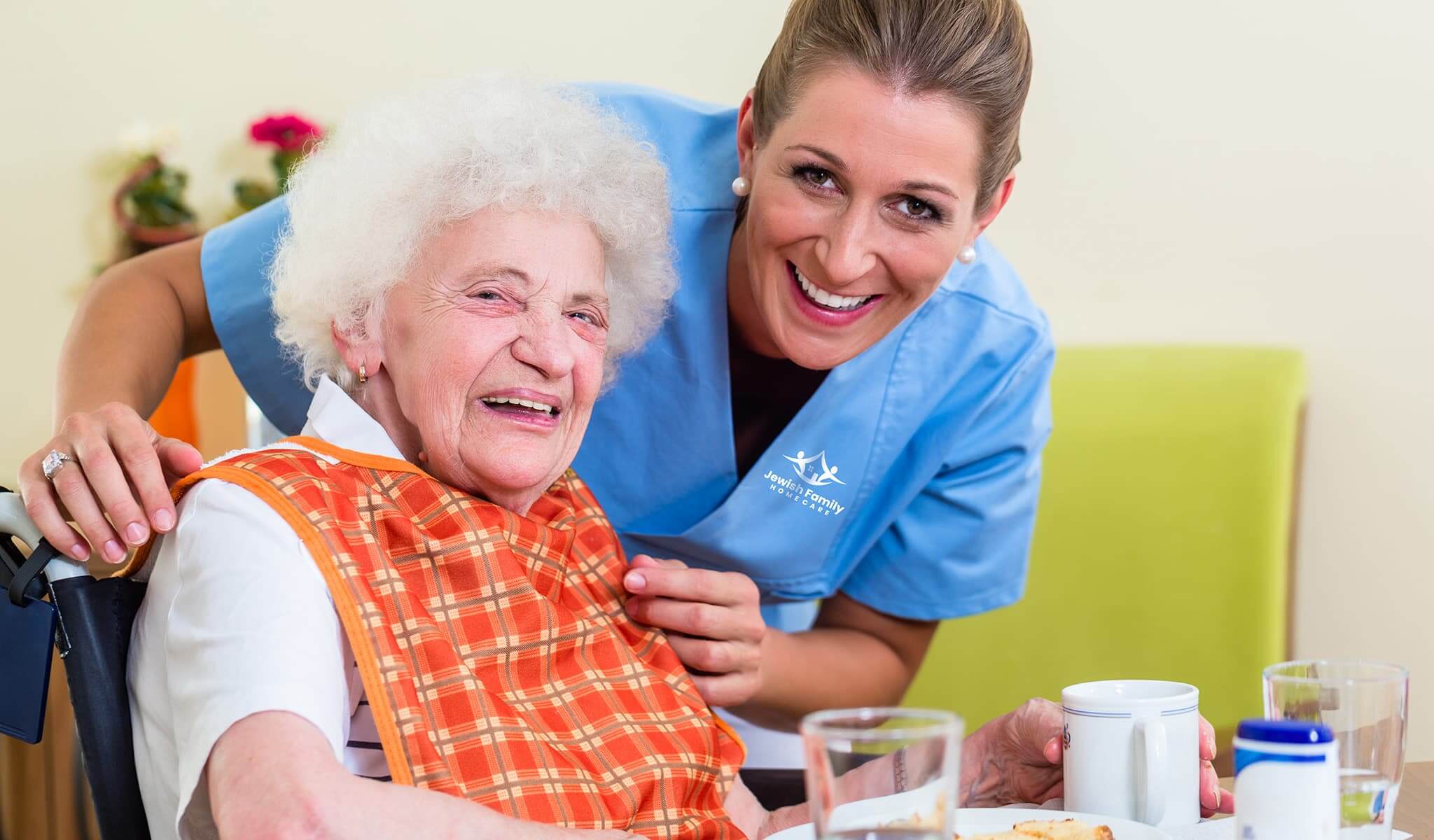 Caregiver assisting senior client with a meal