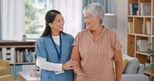 A caregiver demonstrates how home care promotes independent living by helping a client around her home.