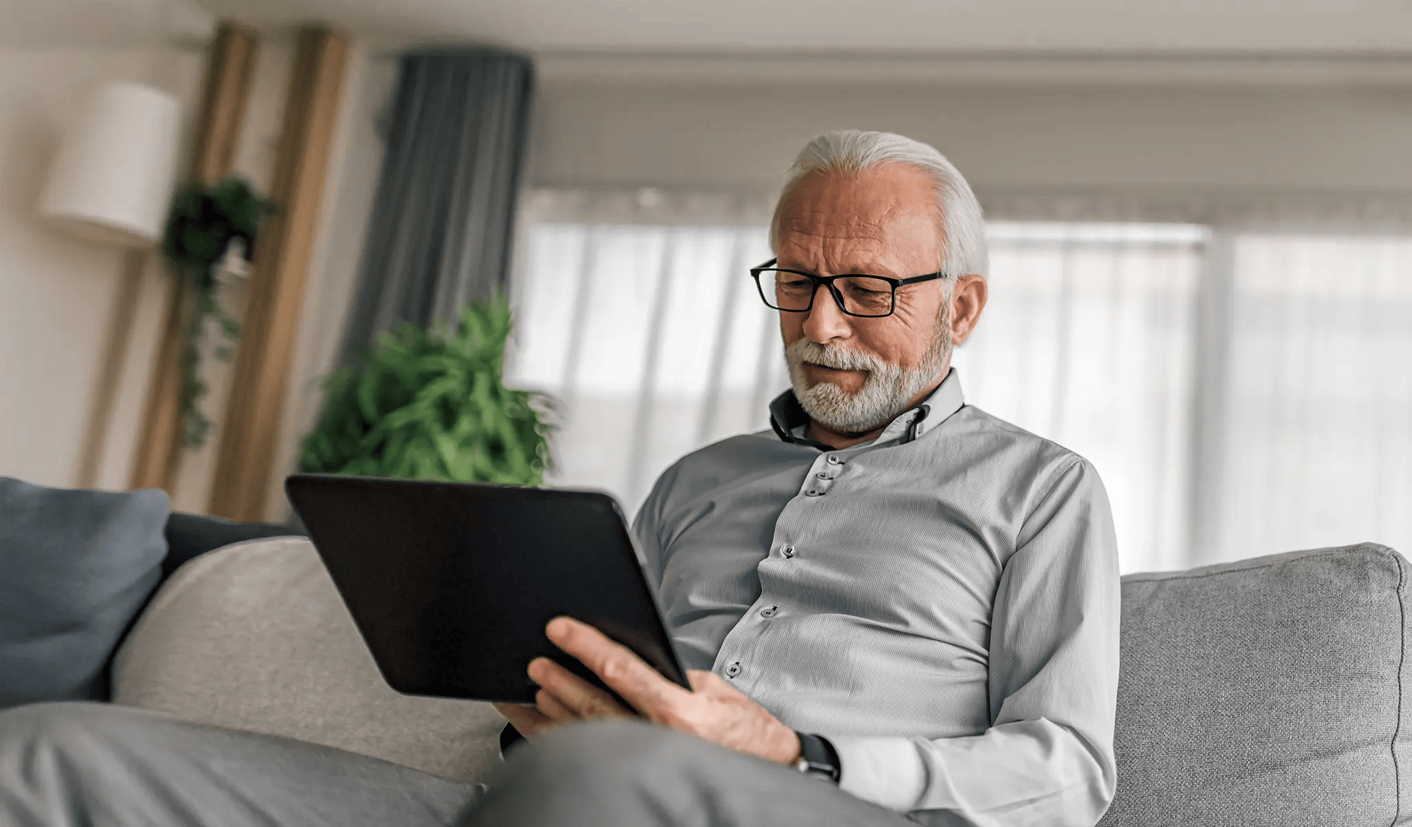holder man reading newsletters on ablet